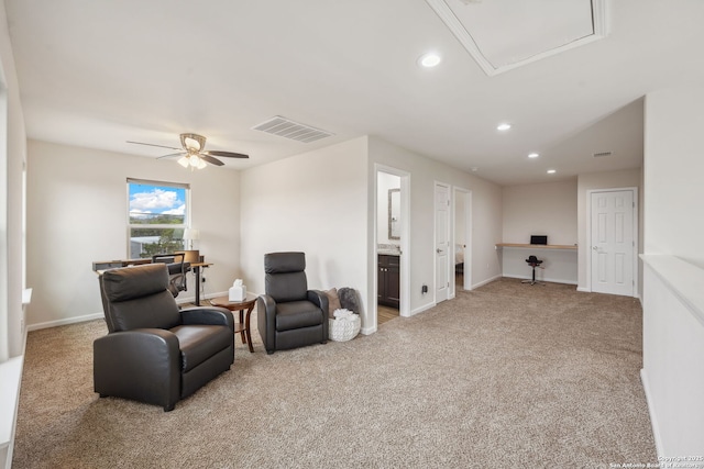 sitting room featuring light carpet and ceiling fan