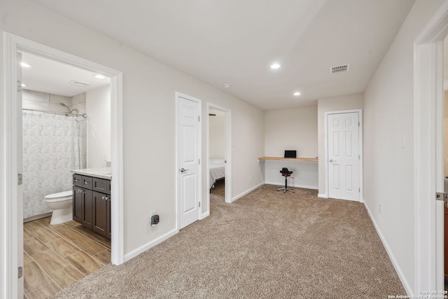 hall featuring light colored carpet