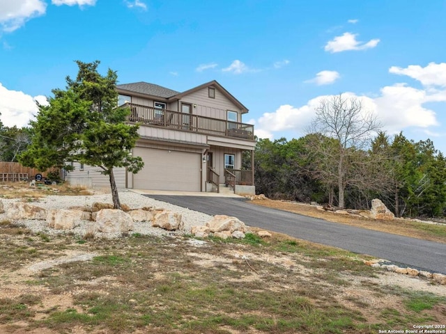 view of front of property with a balcony and a garage