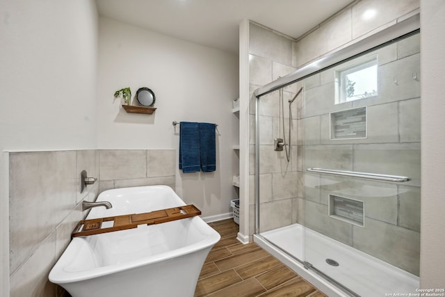 bathroom featuring tile walls and plus walk in shower