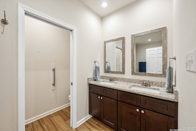 bathroom featuring hardwood / wood-style flooring, vanity, and toilet