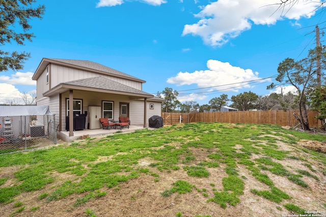 rear view of property with a yard and a patio