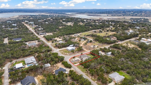 birds eye view of property with a water view