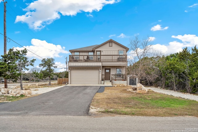 view of front of home featuring a garage and a balcony