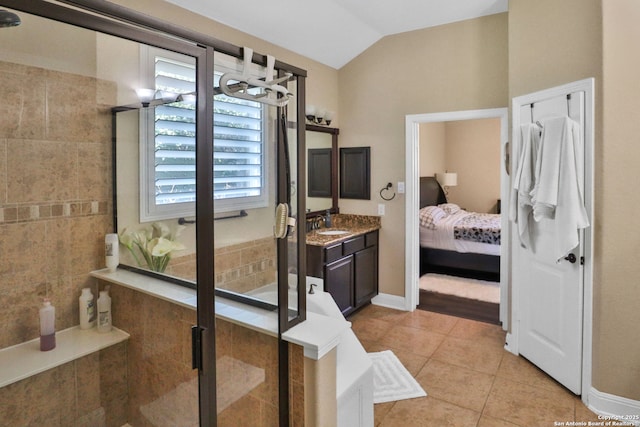 bathroom with an enclosed shower, vanity, tile patterned flooring, and vaulted ceiling