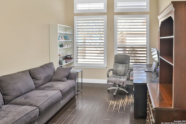 office area with dark hardwood / wood-style floors and a wealth of natural light