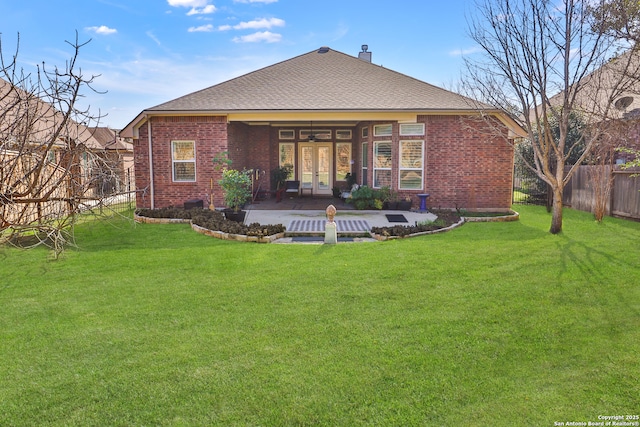 rear view of house featuring a yard, ceiling fan, and a patio area