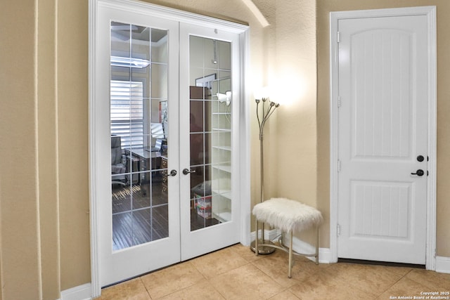 doorway to outside featuring light tile patterned floors and french doors