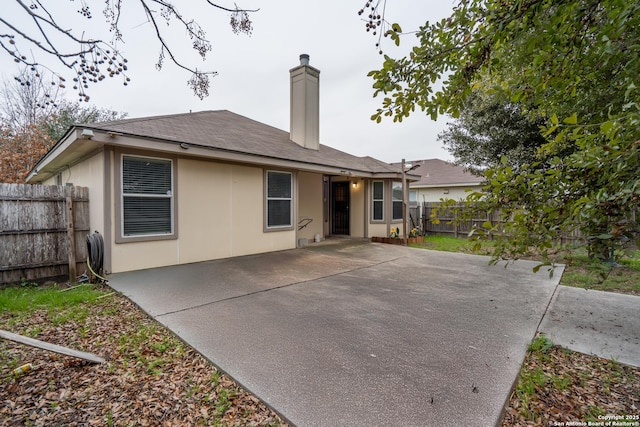 back of property with a patio