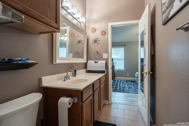 bathroom featuring tile patterned floors, toilet, and vanity