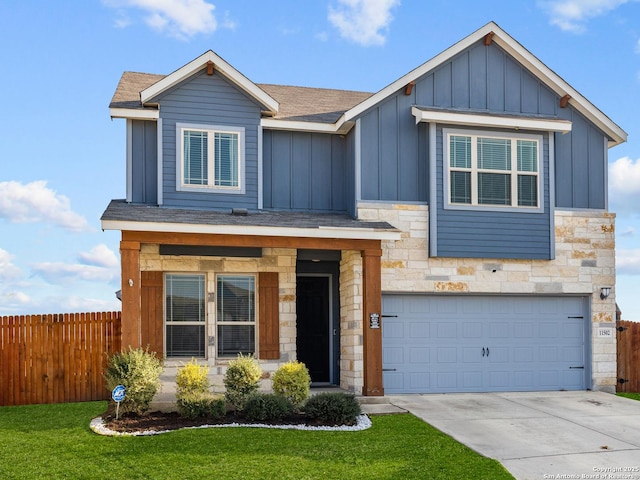 view of front of property featuring a garage and a front lawn