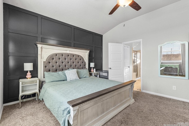 bedroom featuring vaulted ceiling, light colored carpet, ceiling fan, and ensuite bathroom