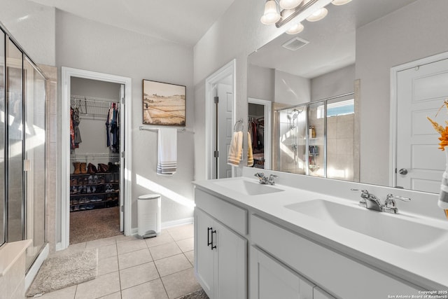 bathroom featuring vanity, an enclosed shower, tile patterned flooring, and a notable chandelier