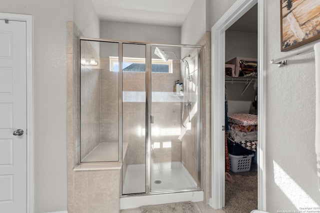 bathroom with a shower with door