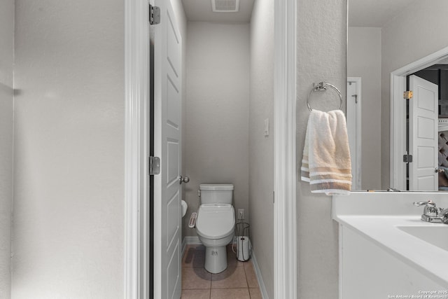 bathroom with tile patterned floors, toilet, and vanity