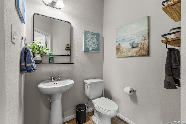 bathroom with sink, hardwood / wood-style flooring, and toilet