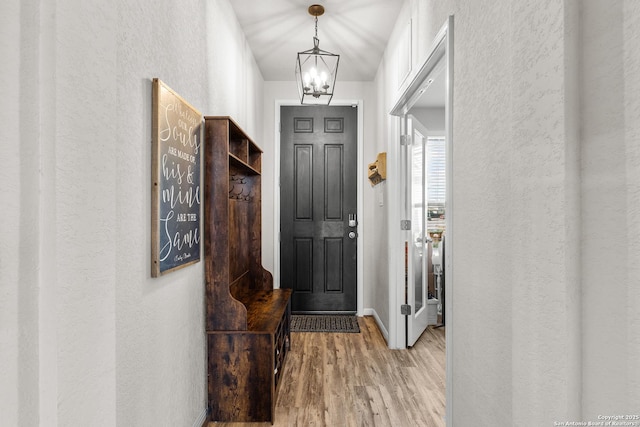 entrance foyer with a chandelier and light hardwood / wood-style flooring