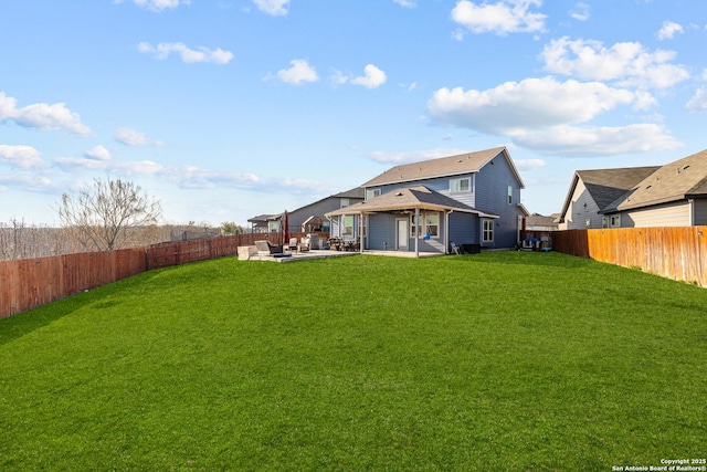 back of house with a yard and a patio