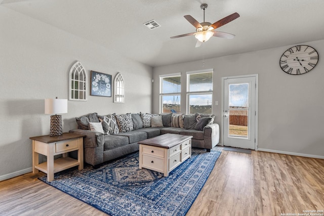 living room with hardwood / wood-style flooring and ceiling fan