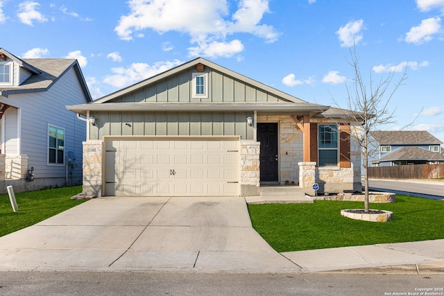 view of front of house featuring a garage and a front lawn