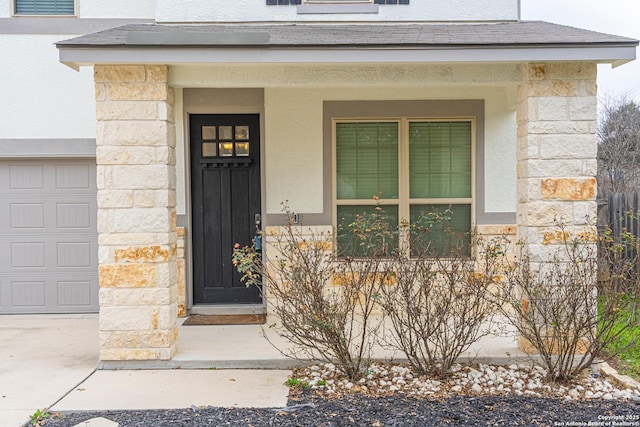 doorway to property with a garage