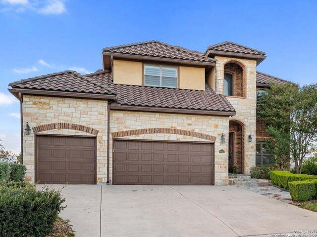 mediterranean / spanish home featuring a garage