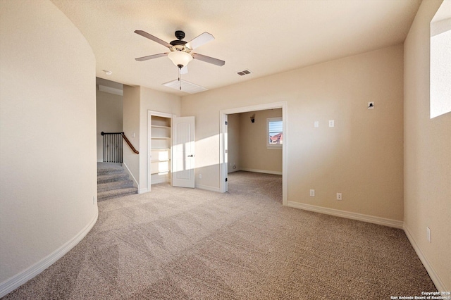 unfurnished room featuring light colored carpet and ceiling fan