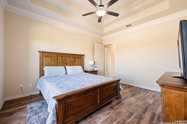 bedroom featuring a raised ceiling and dark wood-type flooring