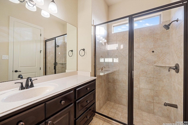 bathroom featuring a shower with shower door and vanity