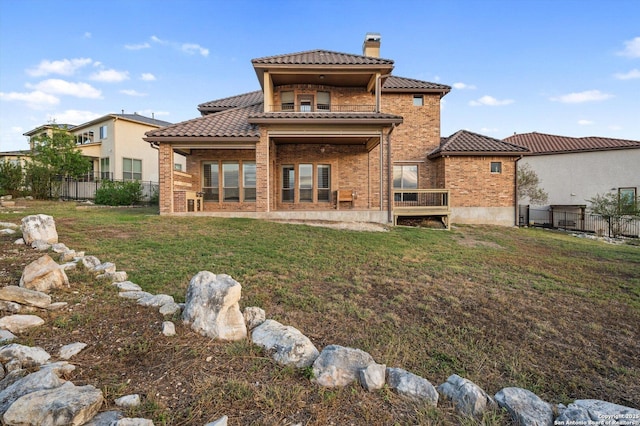 rear view of property with a yard