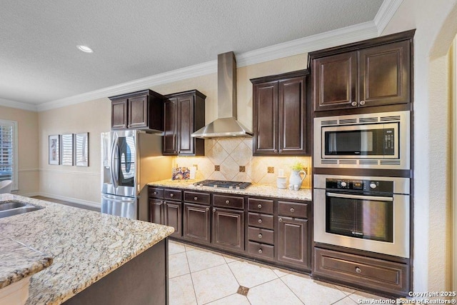 kitchen featuring light tile patterned floors, wall chimney range hood, stainless steel appliances, and dark brown cabinets