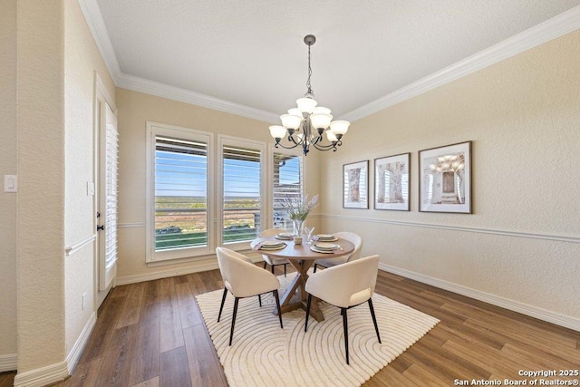 dining area featuring a chandelier, crown molding, and dark hardwood / wood-style floors