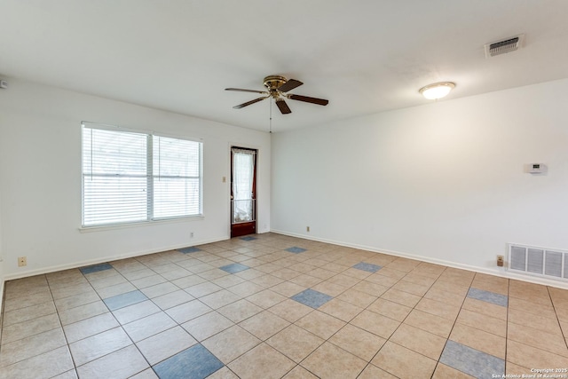 tiled spare room with ceiling fan