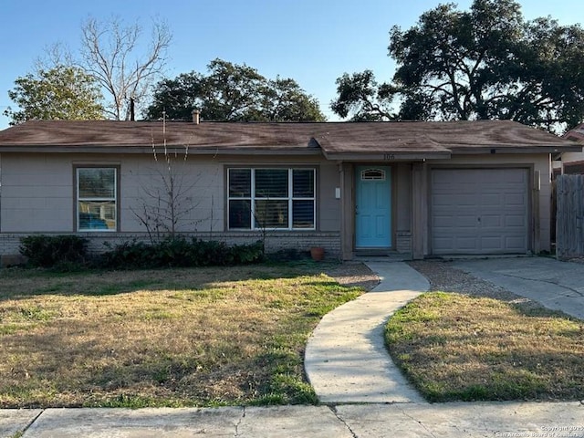 ranch-style home with a garage, brick siding, concrete driveway, and a front yard