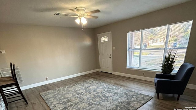 entryway with ceiling fan, baseboards, and dark wood finished floors