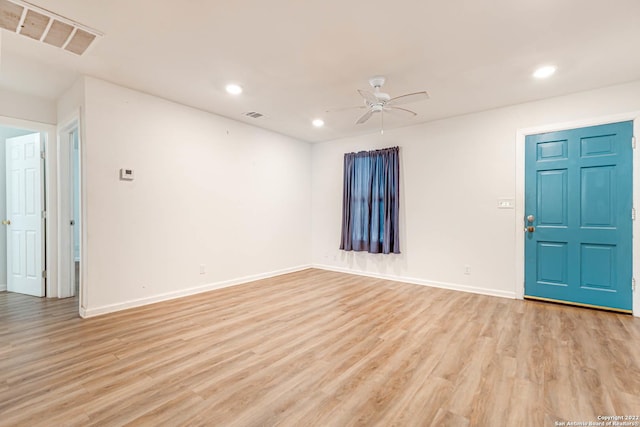 spare room featuring light hardwood / wood-style flooring and ceiling fan