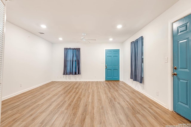 empty room featuring light hardwood / wood-style flooring and ceiling fan