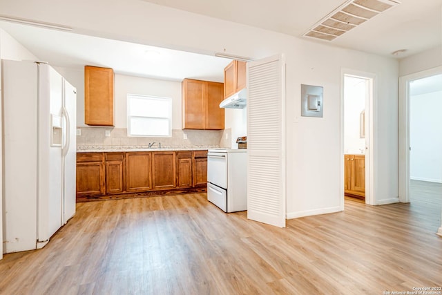 kitchen featuring tasteful backsplash, white appliances, sink, and light wood-type flooring