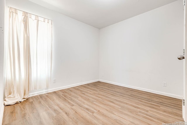 spare room with light hardwood / wood-style flooring