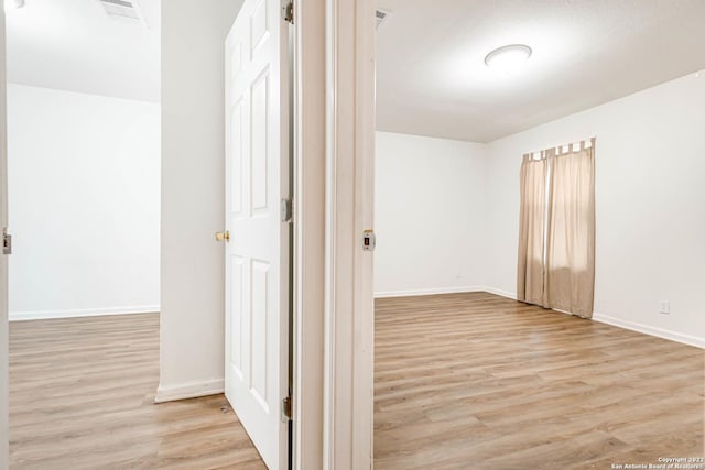 corridor featuring light hardwood / wood-style flooring