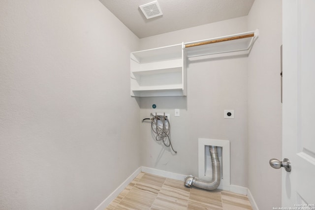 laundry area featuring washer hookup, a textured ceiling, and electric dryer hookup