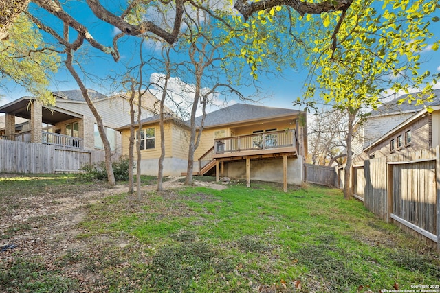 back of property featuring a yard and a deck