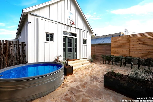 exterior space with an outdoor structure and a patio