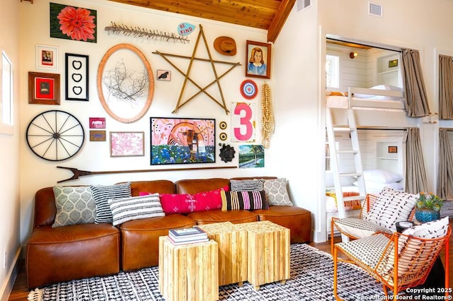 living area with wood-type flooring, vaulted ceiling, and wood ceiling