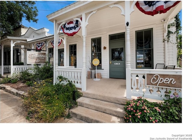 doorway to property featuring covered porch