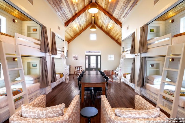 dining space featuring high vaulted ceiling, dark wood-type flooring, wood ceiling, and french doors