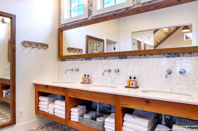 bathroom with vanity, backsplash, and high vaulted ceiling