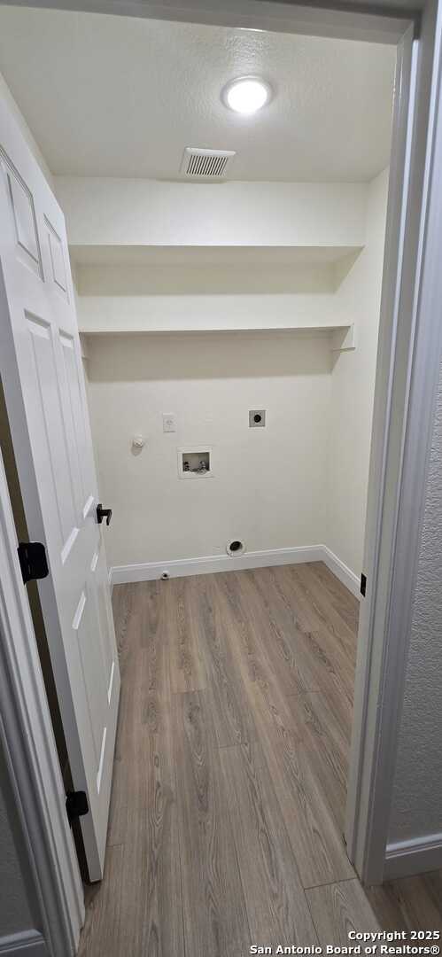 laundry area with gas dryer hookup, hookup for an electric dryer, dark hardwood / wood-style flooring, and hookup for a washing machine