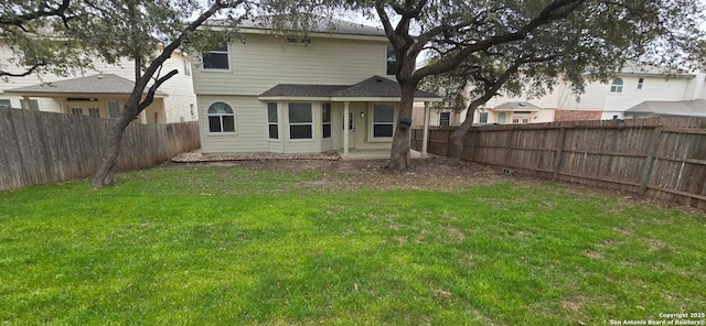 rear view of property with a yard