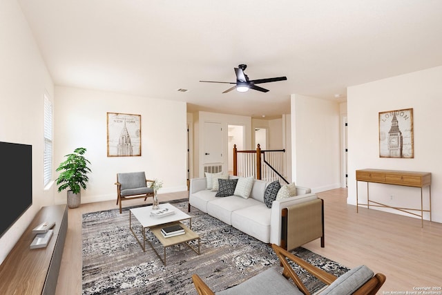 living room with ceiling fan and light hardwood / wood-style floors